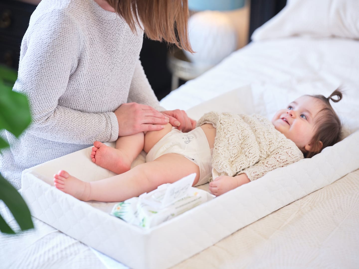 Looking for the best natural baby wipes? Here are our top 11 mom changing a baby's daiper - best natural baby wipes